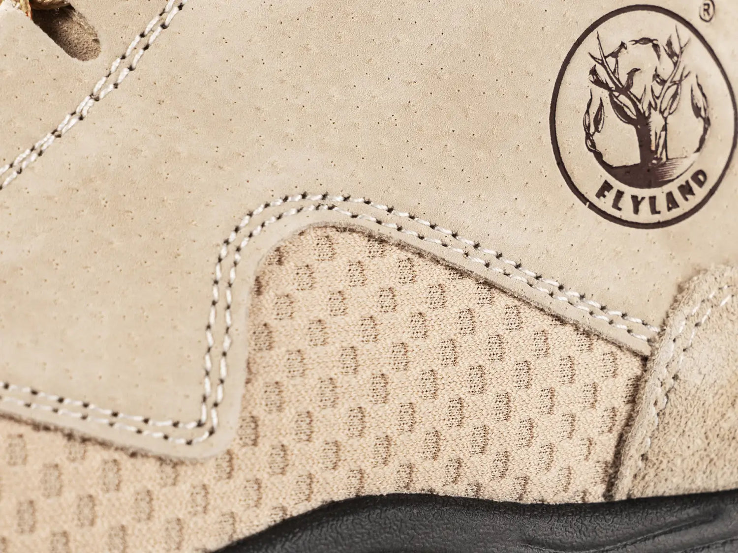 Close-up detail of Flyland summer boots, highlighting the highly efficient breathable mesh panel design for air fluidity and the embossed brand logo.