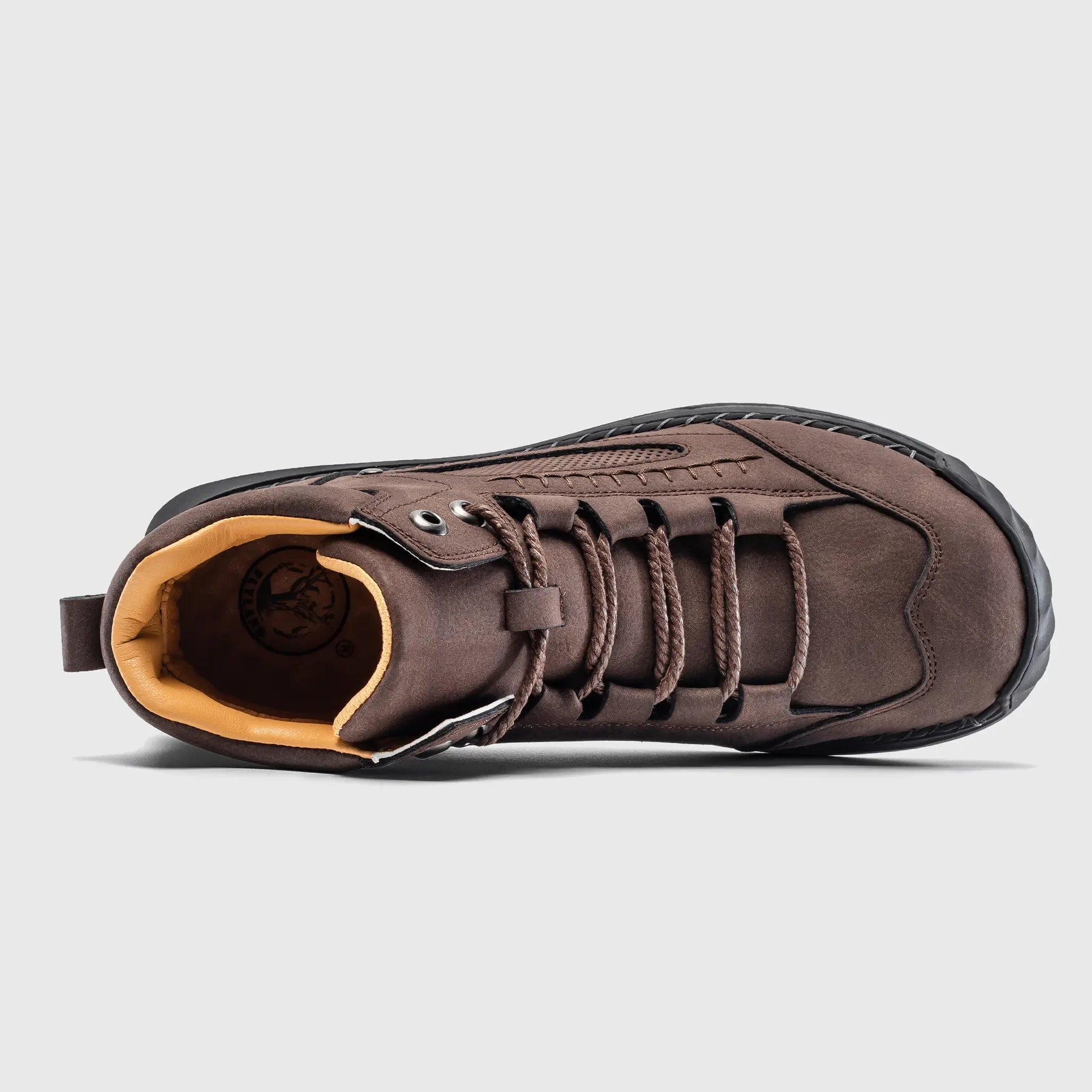 Top down view into Flyland brown ankle boots, displaying the roomy toe box and breathable interior lining.