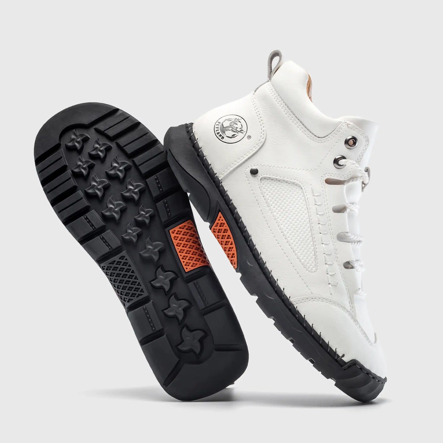 Durable black rubber outsole of Flyland white casual boots, designed with non-slip traction for stability.