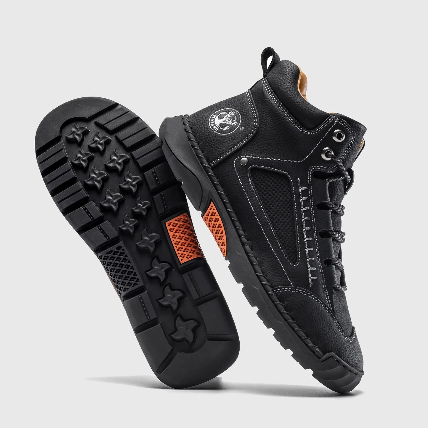 Durable rubber outsole of Flyland black casual boots, featuring a non-slip pattern for urban walking.