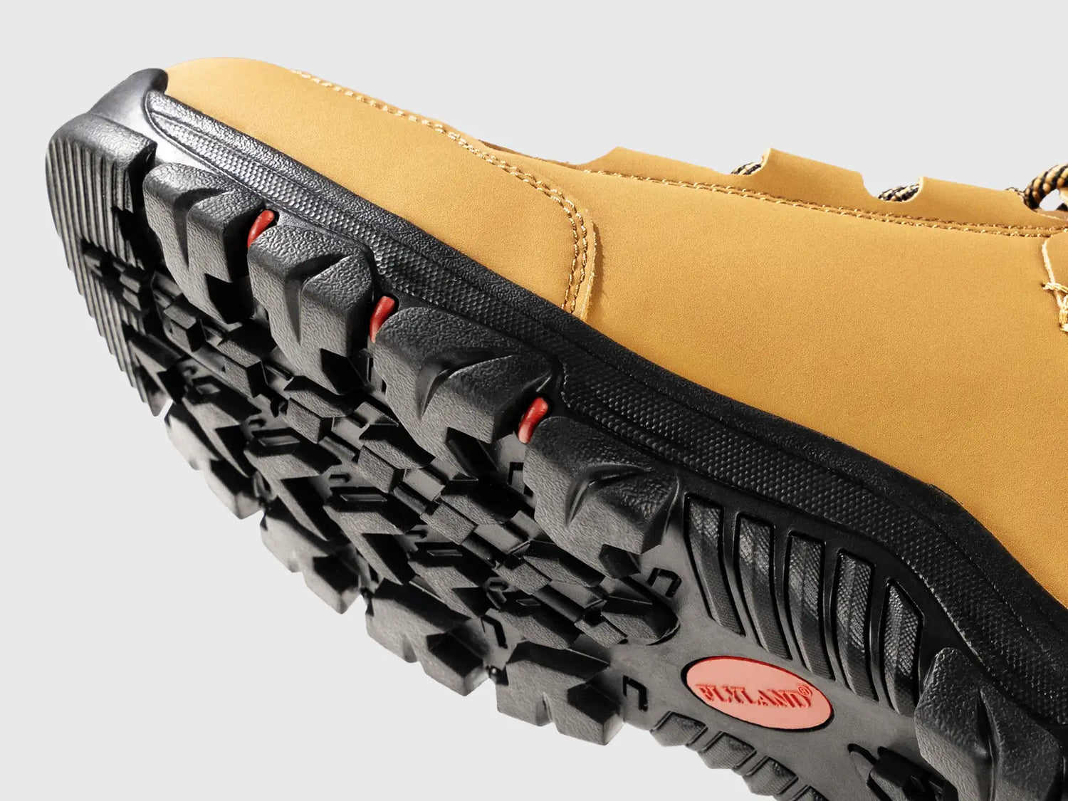 Close-up view of the rugged rubber outsole on Flyland walking boots, selected for prolong and tough durability to withstand daily wear and tear.