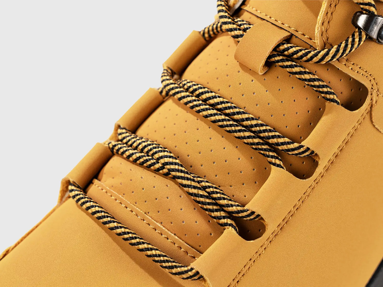 Close-up detail of Flyland lightweight boots featuring a durable lacing system and perforated tongue, designed as a savior for tedious walks.