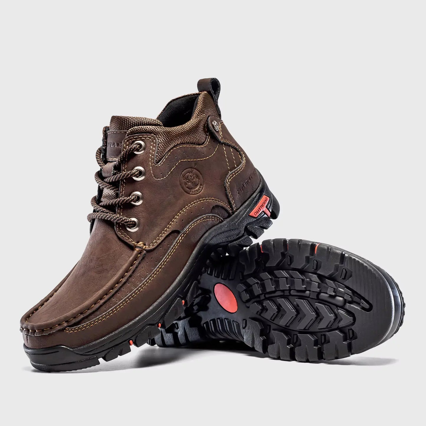 Non-slip rubber outsole traction of Flyland Land2511 brown boots for rough terrain.
