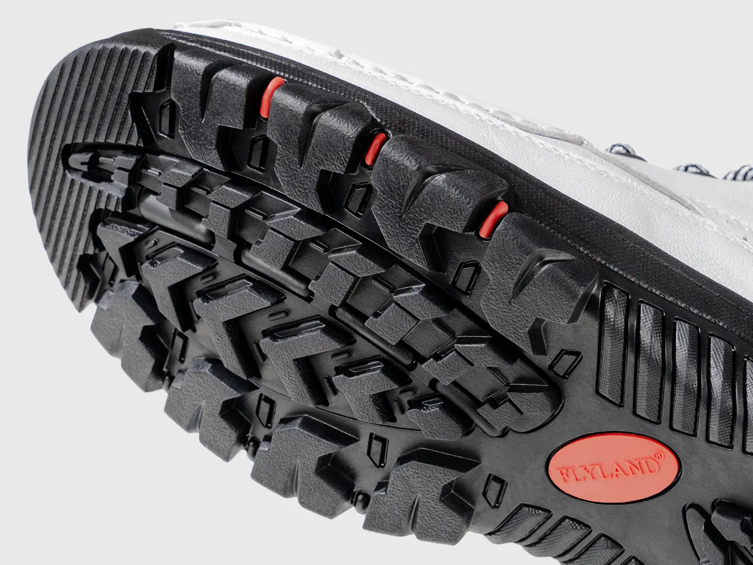 Close-up view of the rugged anti-slip rubber outsole on Flyland Land2511 boots, ensuring superior traction and adaptation with multi-functionality for various terrains.
