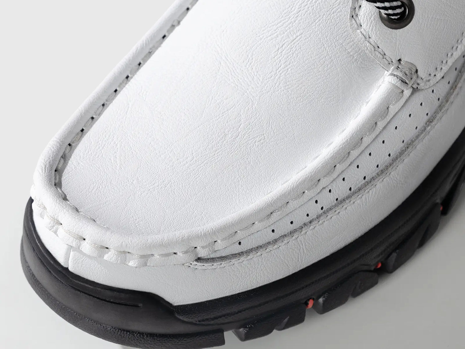 A stylish pair of Flyland Land2511 men's white sneaker boots, showcasing a modern twist on the classic moc toe design with contrasting black soles.