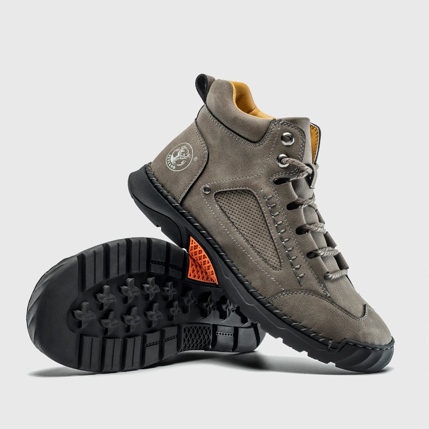 Bottom view of Flyland gray boots. The design combines a minimalist plain toe aesthetic with a flexible flat sole.