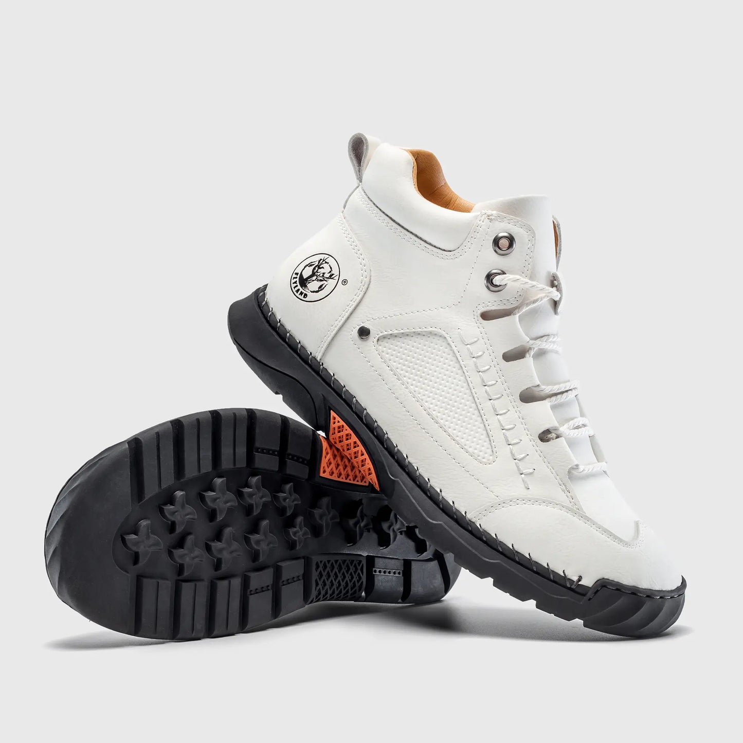 Bottom view of Flyland white boots. The design features a minimalist plain toe aesthetic with a flexible sneaker sole.