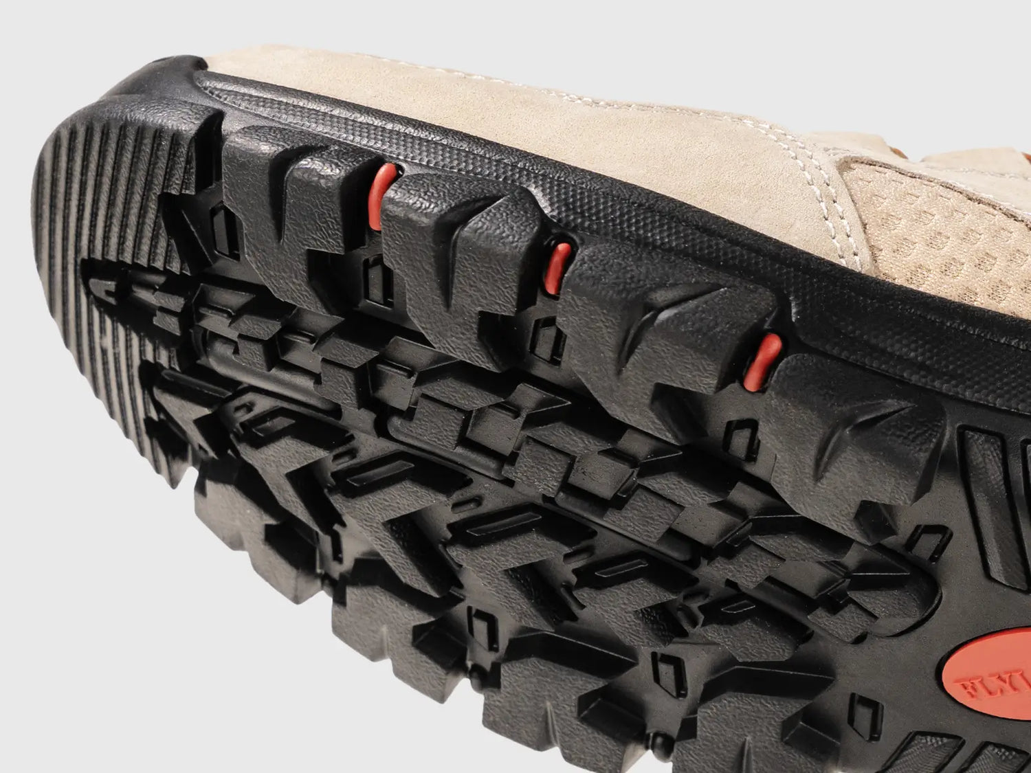 Close-up view of the rugged rubber outsole on Flyland boots, featuring deep tread patterns for fabulous friction and shock absorption on urban expeditions.