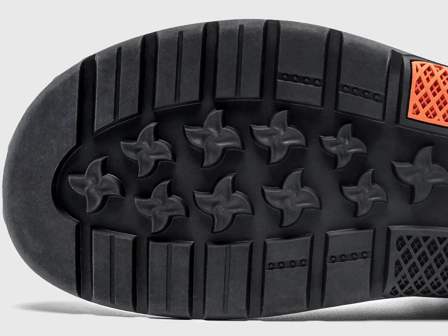 Close-up view of the durable rubber boot sole featuring the unique shuriken outsole tread pattern for enhanced grip.