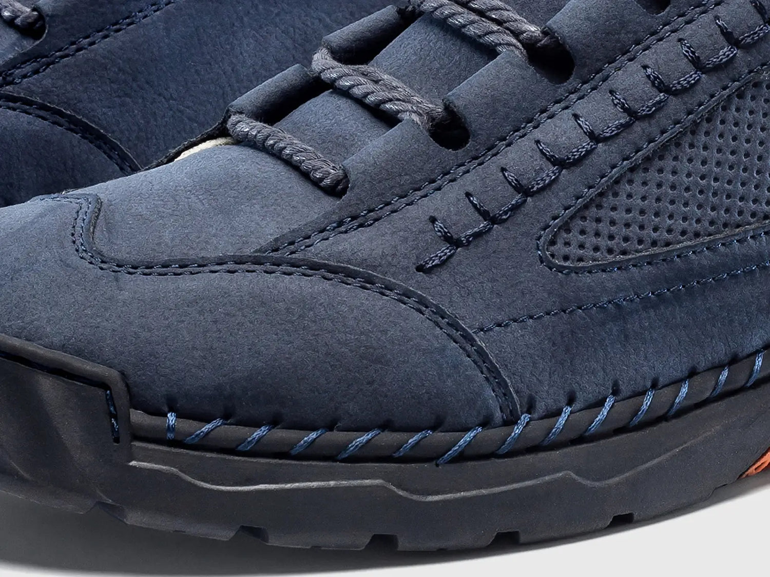 Close-up detail of the men's boot highlighting the rugged hand-stitched seams across the suede-like toe box.
