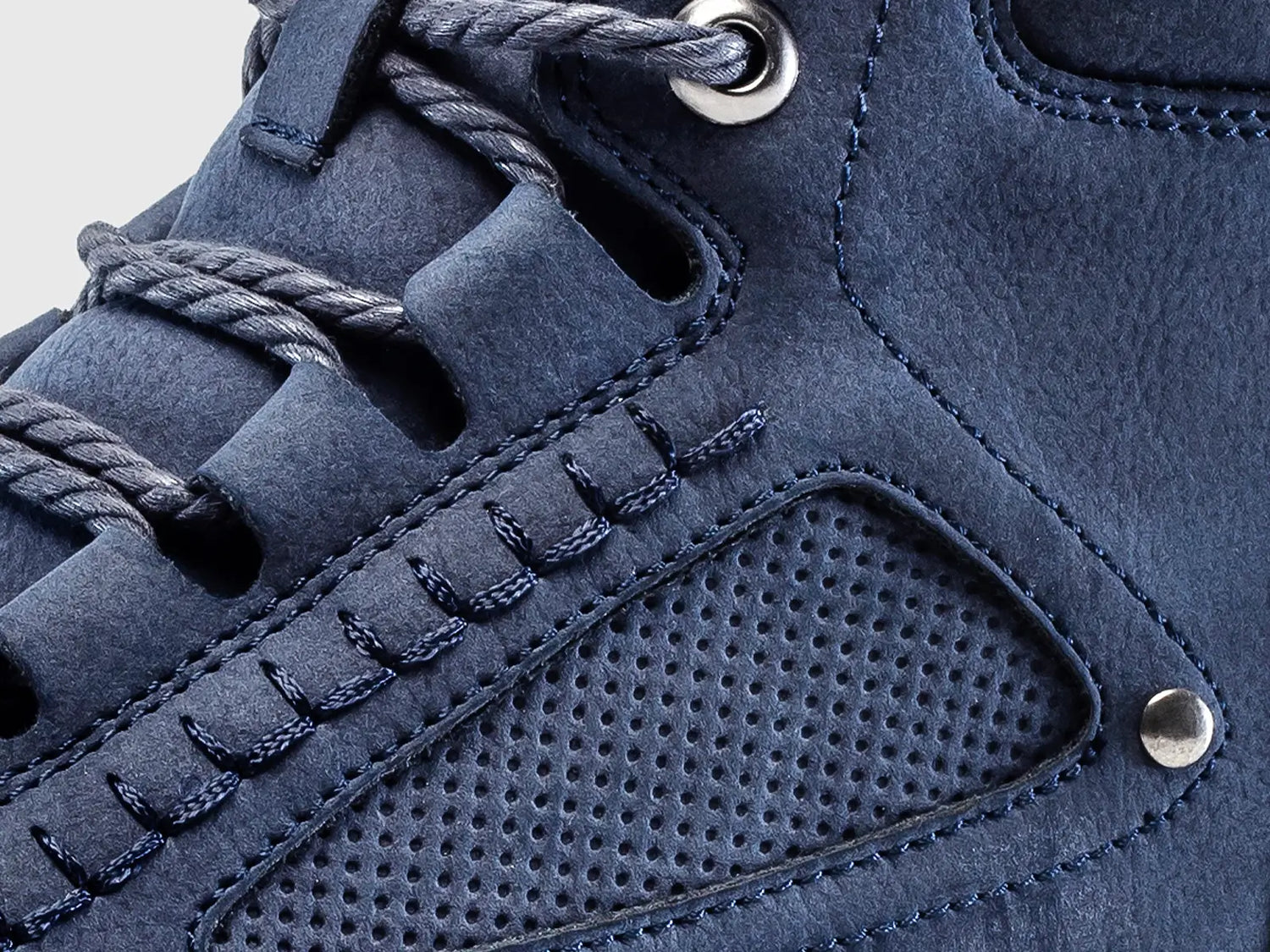 Detailed view of the boot's side panel, showcasing the perforated design, sturdy lacing, and the soft material crafted for a superior touch.